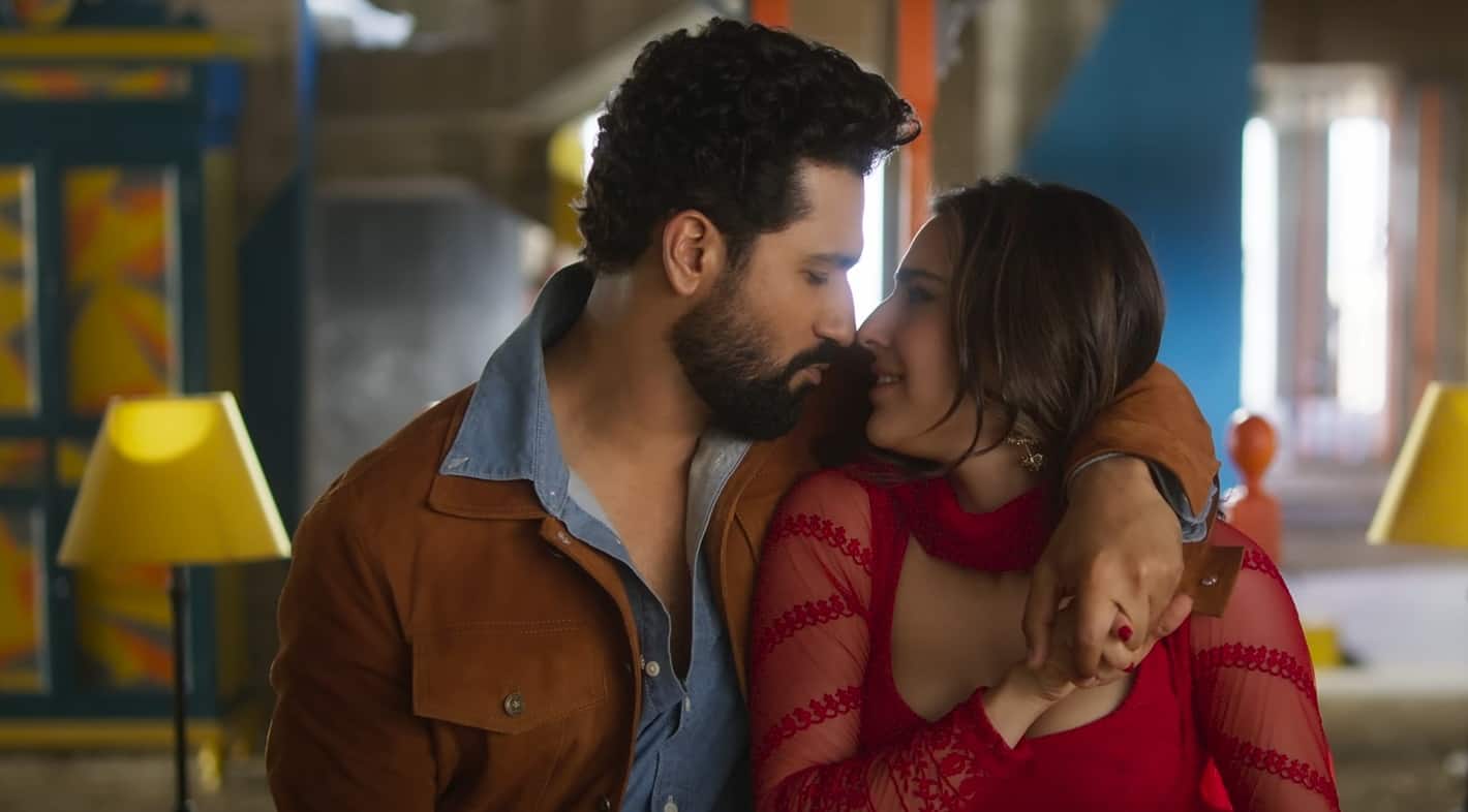 Vicky Kaushal is wearing a Brown jacket and he is seen along with Sara Ali Khan who is wearing a red suit. They both are cuddling and the song is Tere Vaste Lyrics from Zara Hatke Zara Bachke Movie